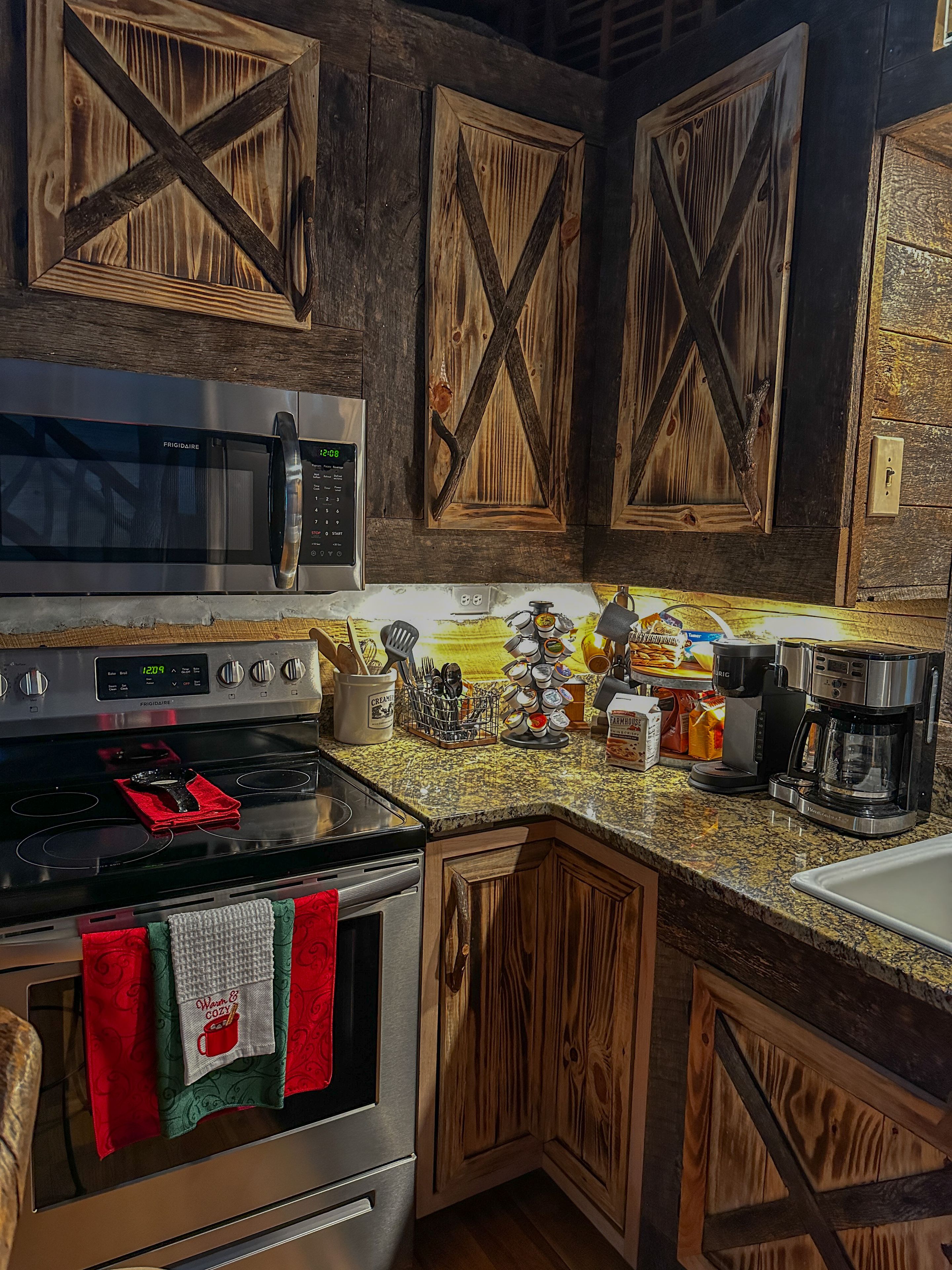 A kitchen with wooden cabinets, a stainless steel stove, and a coffee maker.