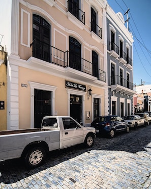 A street with a building labeled 'Hotel La Terrazza' with a white pick-up truck parked in front. - Patio Elba Old San Juan (San Juan)