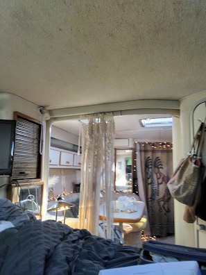 A compact living space with a bed, a window, and a curtain. - 2-bedroom boat in fabulous Key West with kayaks (Key West)