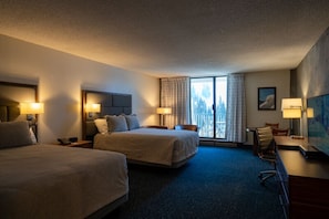 A hotel room with two beds, a desk, a chair, and a large window with curtains. - Snowbird Iron Blosam Lodge - Bedroom and Studio Hotel Apartment (Snowbird)