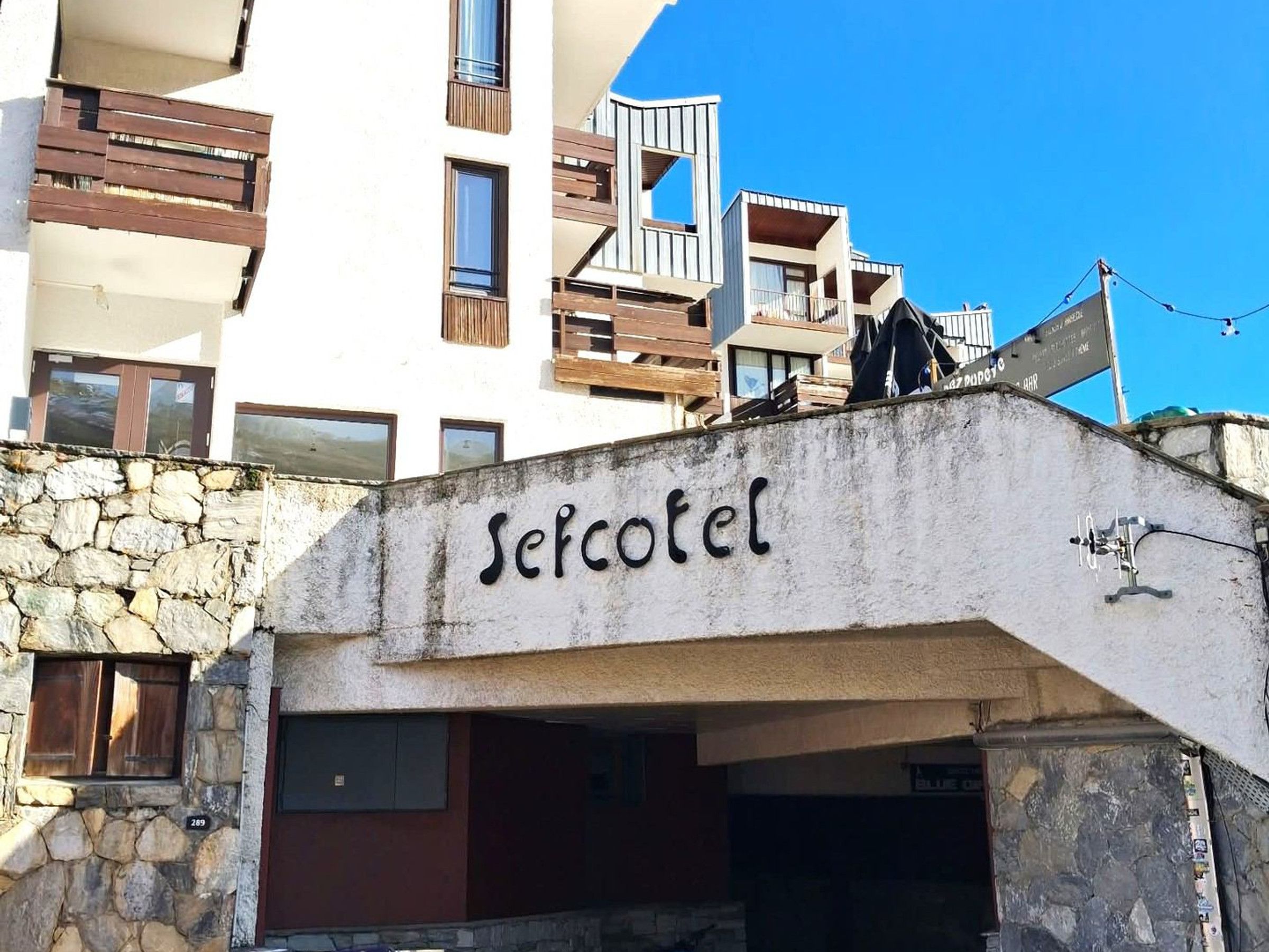 A building with a stone facade and a sign that reads 'Secotel.'
