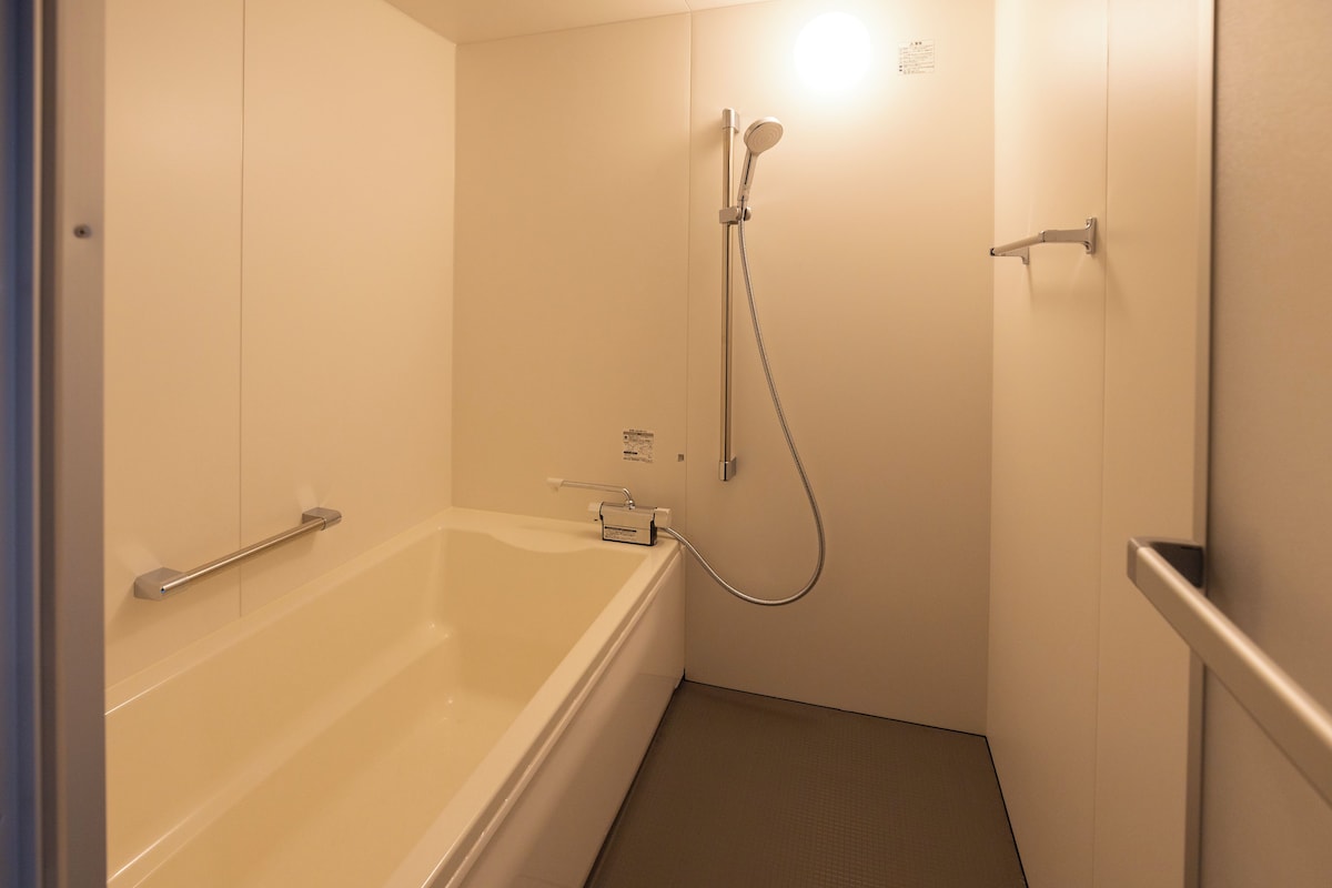 A bathroom with a bathtub, a shower, and a toilet.