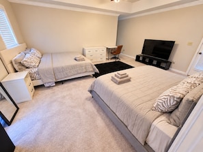 A bedroom with two beds, a TV, a desk, and a chair. - Cozy, Clean, Home with lots of things to do, Great for Short or Long term stays (Montgomery)