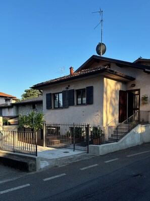 A residential building with a satellite dish, a chimney, and a gated entrance. - New Listing (Corte Franca)