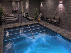 An indoor swimming pool with a diving board, lounge chairs, and a staircase leading to an upper level. - Ski in/Ski out 1 bedroom luxury condo suite sleeps 4 Breckenridge Peak 8 resort (Breckenridge)