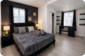 A bedroom with a large bed, bedside tables, a desk, and a wardrobe. - Private hot tub. Miami can wait. (Miami)