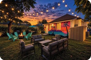 An outdoor patio with string lights, a fire pit, and outdoor furniture. - Private hot tub. Miami can wait. (Miami)