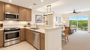 A modern kitchen with stainless steel appliances, wooden cabinets, and a central island. - Marriott's Gorgeous Beachfront Waiohai Club Resort + Resort Amenities Included (Koloa)