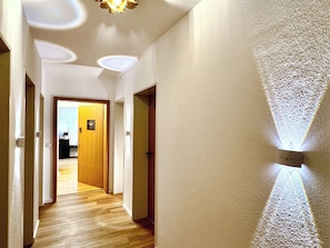 A hallway with wooden flooring, white walls, and a ceiling with recessed lighting. - New Listing (Bad Krozingen)