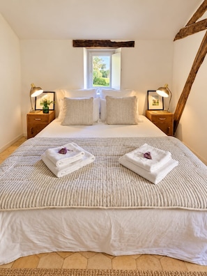 A bedroom with a large bed, two bedside tables with lamps, a window, and a wooden beam ceiling. - New Listing (Val de Louyre et Caudeau)