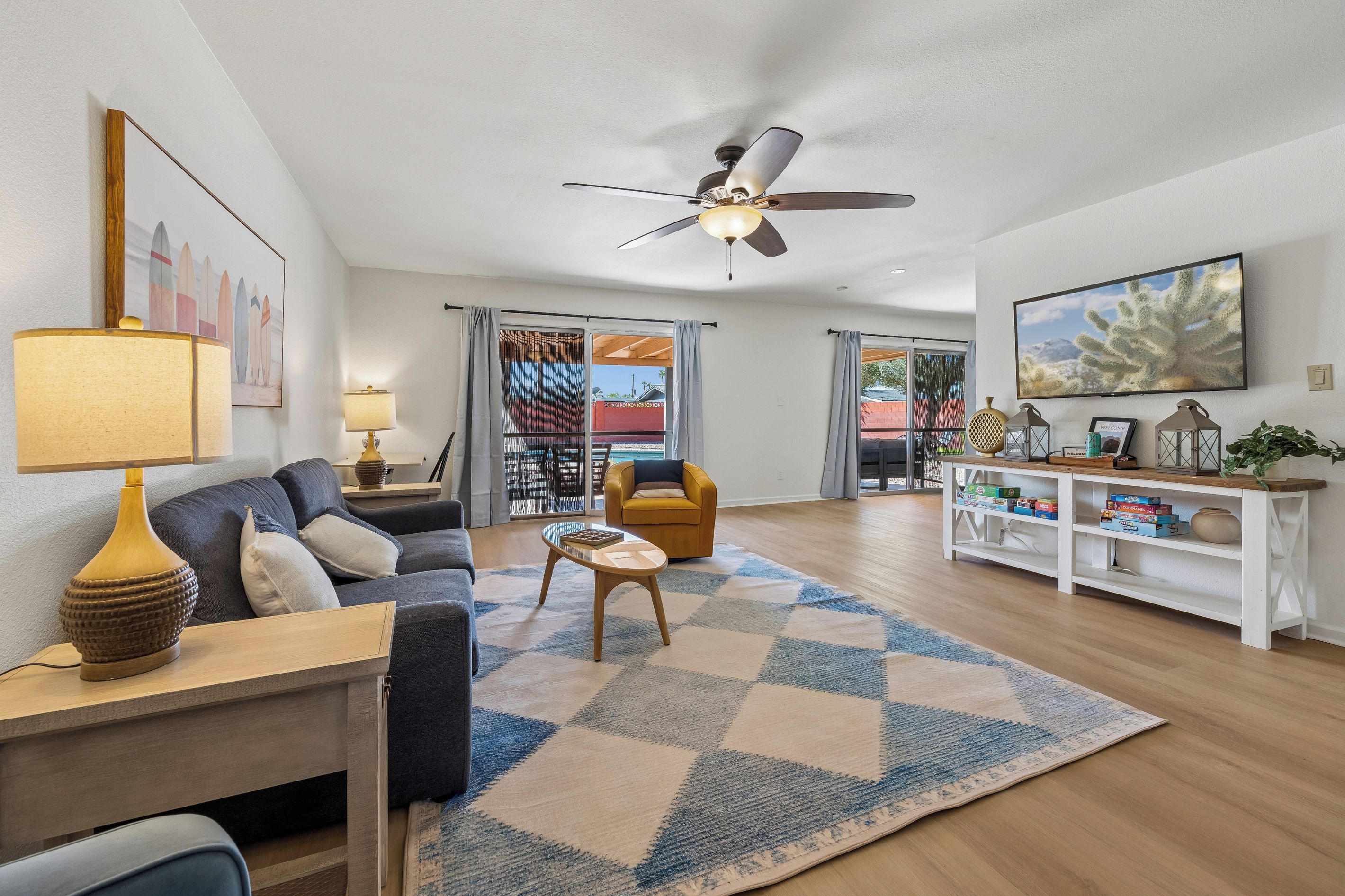 A modern living room with a sofa, coffee table, and a ceiling fan.