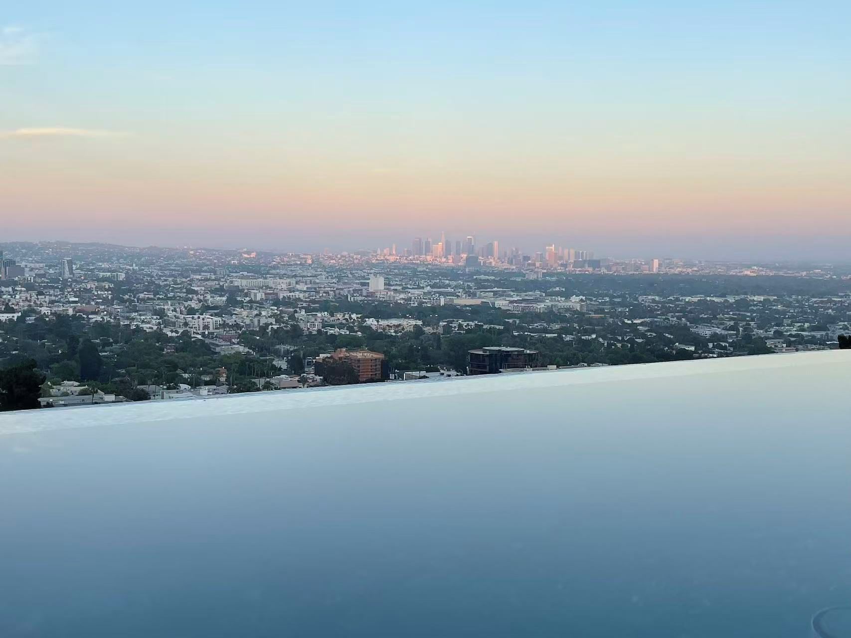 A panoramic view of a cityscape with buildings and greenery.
