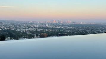 A panoramic view of a cityscape with buildings and greenery.