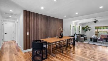 A modern interior with a dining area, a living room, and a kitchen.