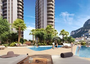 A poolside area with lounge chairs, a pool, and a view of tall buildings and a mountain. - VV -Skyline Large Studio| Pool Gym| City Centre #2 (Gibraltar)