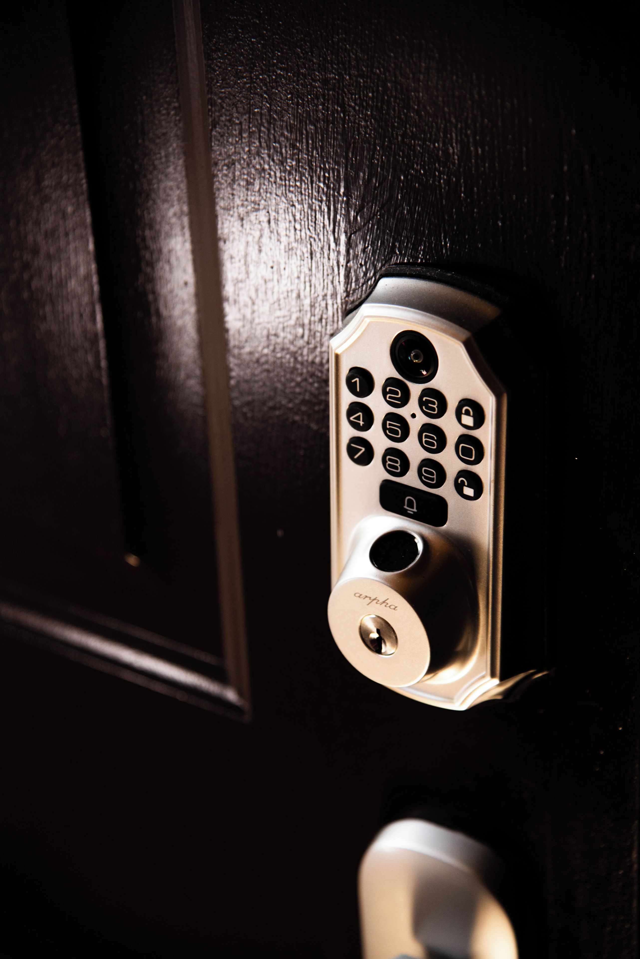 A door lock with a numeric keypad and a keyhole.