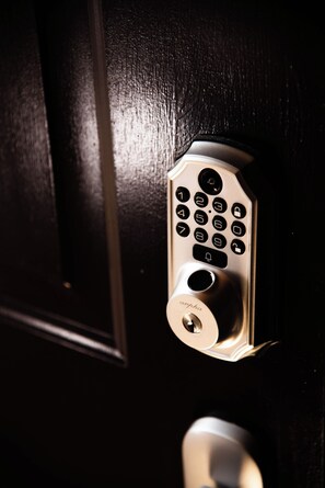 A door lock with a numeric keypad and a keyhole.