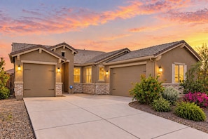 A two-story house with a garage, a driveway, and a landscaped garden. - Entire home in Goodyear, Arizona, United States (Goodyear)