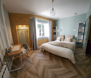 A bedroom with a bed, a desk with a chair, a mirror, and a window with curtains. - New Listing (Hure)