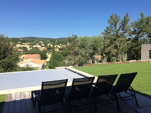 Una terraza con vista a una zona residencial, con casas y árboles.