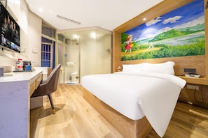 A hotel room with a bed, a desk with a chair, a painting on the wall, and a shower area. - Jinglai Hotel - Shanghai South Bund Xintiandi Branch (Shanghai)