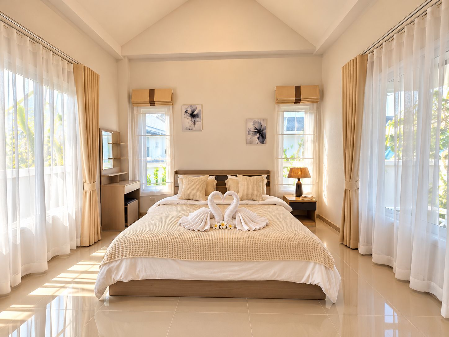 A spacious bedroom with a large bed, two bedside tables, a nightstand, and a window with curtains.