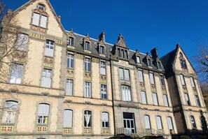 A historic building with multiple windows and a prominent entrance. - New Listing (La Bourboule)