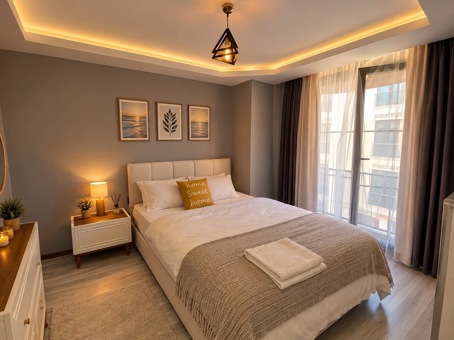A modern bedroom with a large bed, bedside lamps, a nightstand, and a view of the outside through a window.