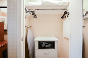 A compact hotel room with a bed, a small bedside table with a microwave, and a closet with hanging clothes. - 2 Bedroom 3 BTH balcony Cojoined collection at MGM SIGNATURE StripSuite Hotel & Resort - NO RESORT FEE (Las Vegas)
