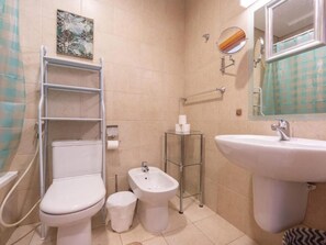A bathroom with a toilet, bidet, shelf unit, and sink. - Zigzag Tower B-Honeymoon Suit, 2 Bedroom at 32 floor In Pearl-3201B (Lusail)