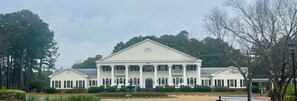 A large white building with a symmetrical facade, columns, and a central entrance. - Two bedroom condo overlooking fairways of Calabash golf course. (Calabash)