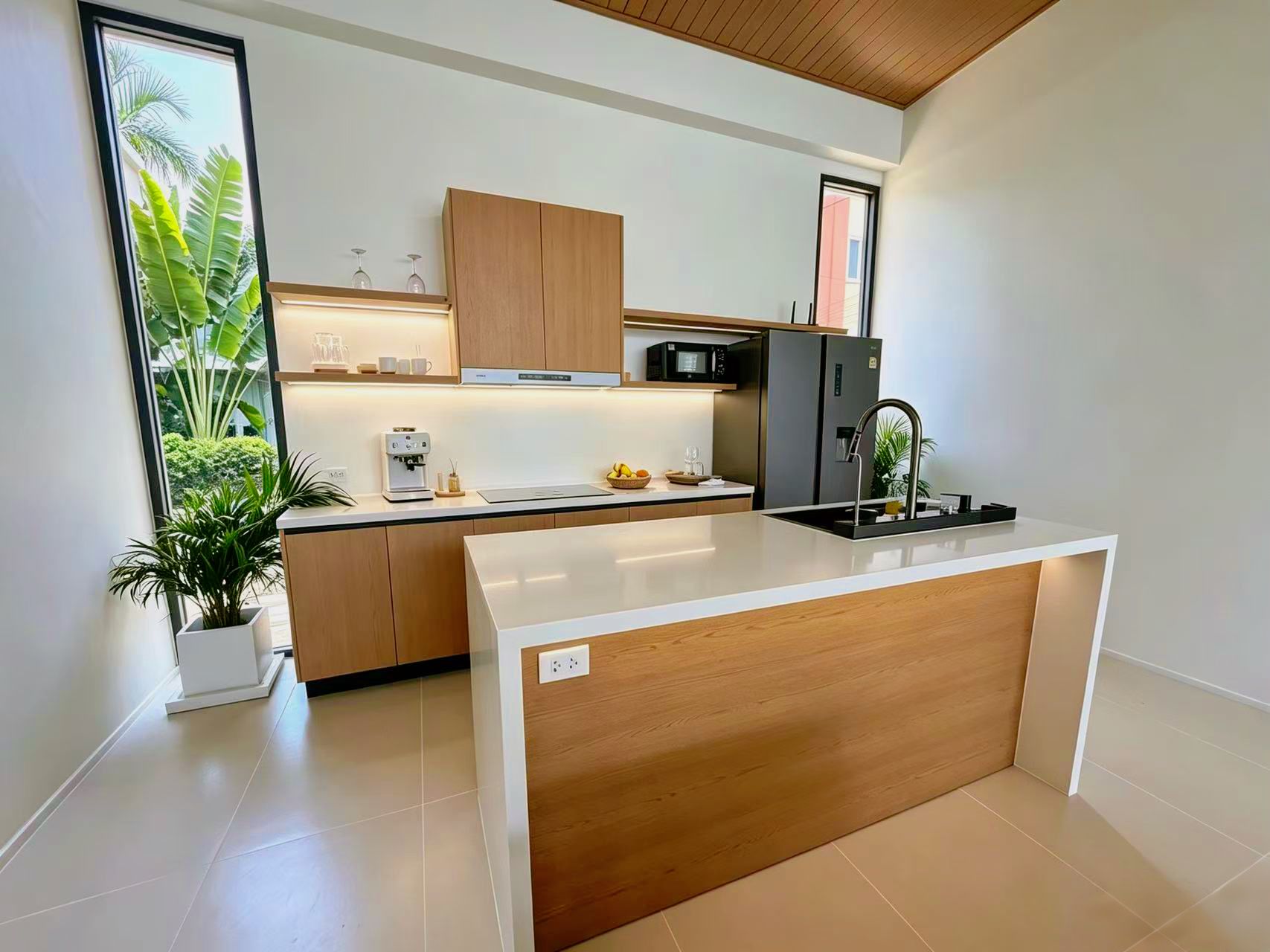 A modern kitchen with a central island, wooden cabinets, a built-in microwave, and a sink.