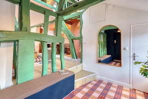 A room with a high ceiling, exposed wooden beams, a checkered floor, and a door with a mirror. - New Listing (Rouen)