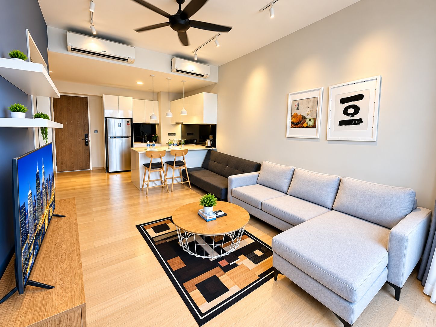 A modern living room with a grey sofa, a coffee table, and a TV.