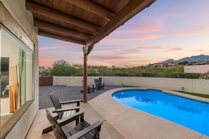 Fully fenced backyard oasis with fire pit, private pool (unheated), cozy seating, and stunning views
