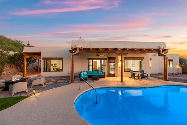 Fully fenced backyard oasis with fire pit, private pool (unheated), cozy seating, and stunning views