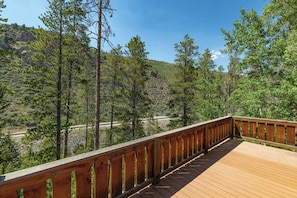 A wooden deck with a view of a forested hillside. - West Vail Modern (Vail)