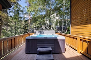 A hot tub on a wooden deck surrounded by trees. - West Vail Modern (Vail)