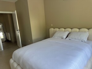 A bedroom with a bed, a radiator, and a door leading to another room. - New Listing (Profondeville)
