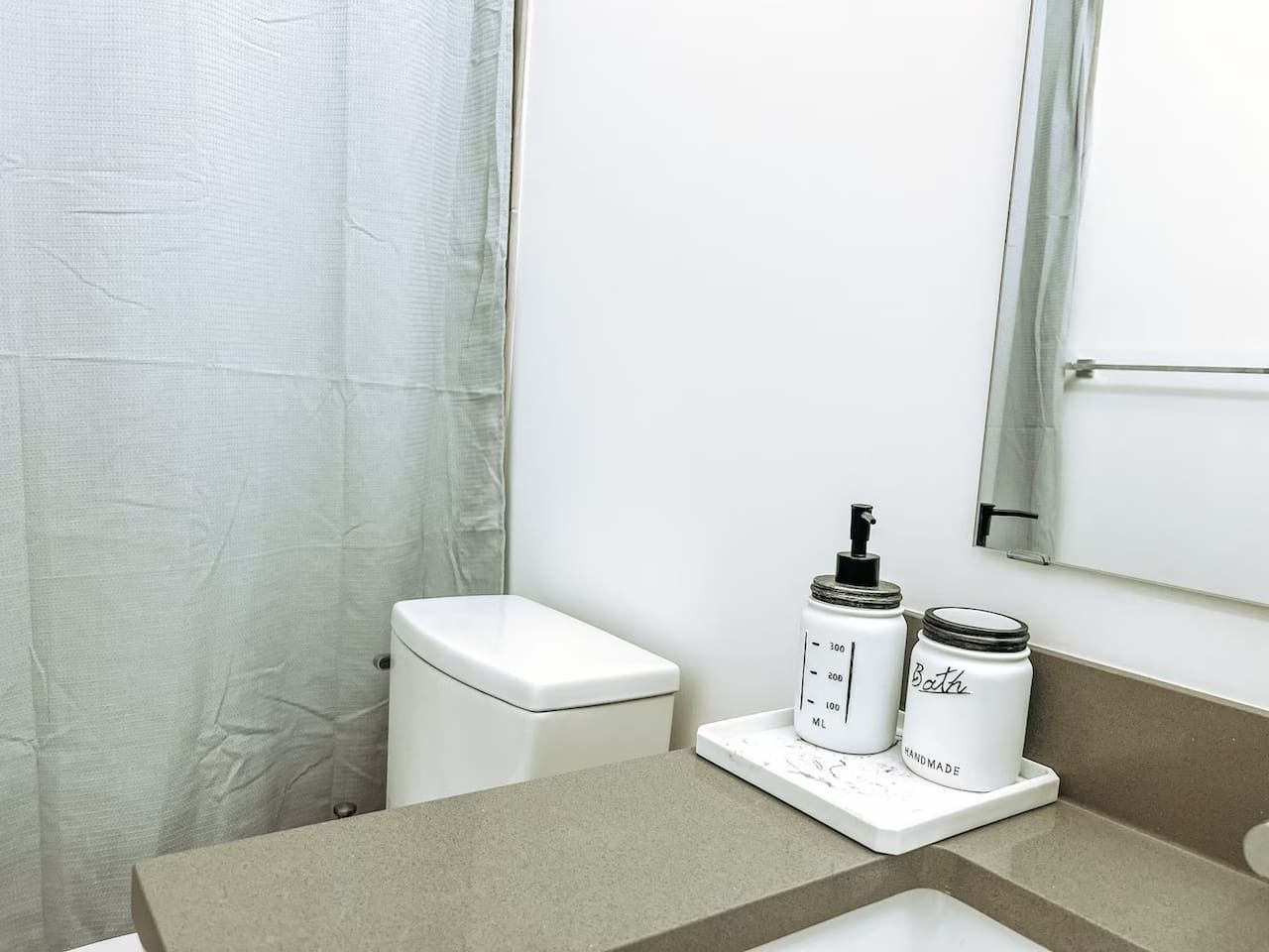 A bathroom with a toilet, a sink, and a shower curtain.