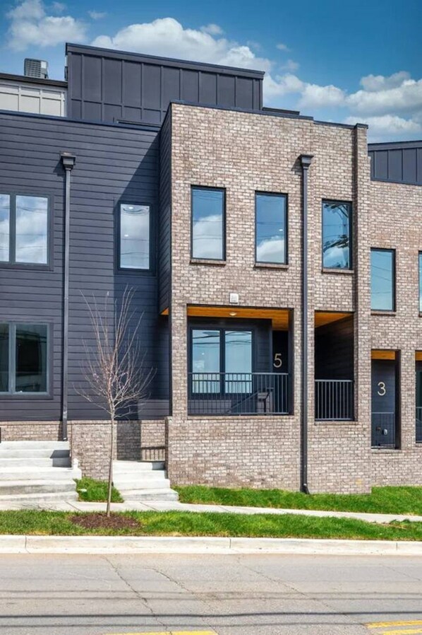 A modern two-story building with a brick facade and large windows.