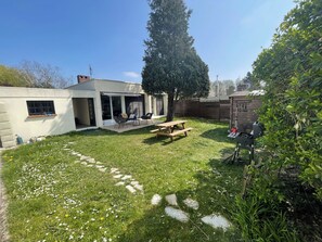 A backyard with a patio, a barbecue area, and a wooden fence. - Beautiful 3 bdr villa close to CDG airport/ villepinte/ Paris (Aulnay-sous-Bois)