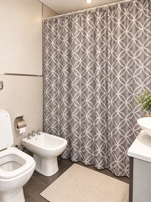 A bathroom with a toilet, bidet, and sink. - CANNIG CENTER  (Canning)