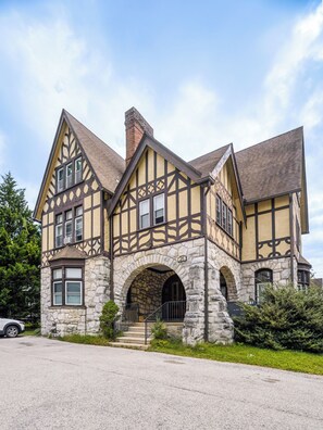 A traditional half-timbered house with a stone archway entrance, multiple windows, and a visible address number. - Bryn Mawr 1st Floor Apartment / Near Villanova (Bryn Mawr)