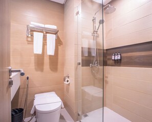 A modern bathroom with a glass-enclosed shower, a toilet, and a towel rack. - Galilea Hotel Bohol (Tagbilaran)