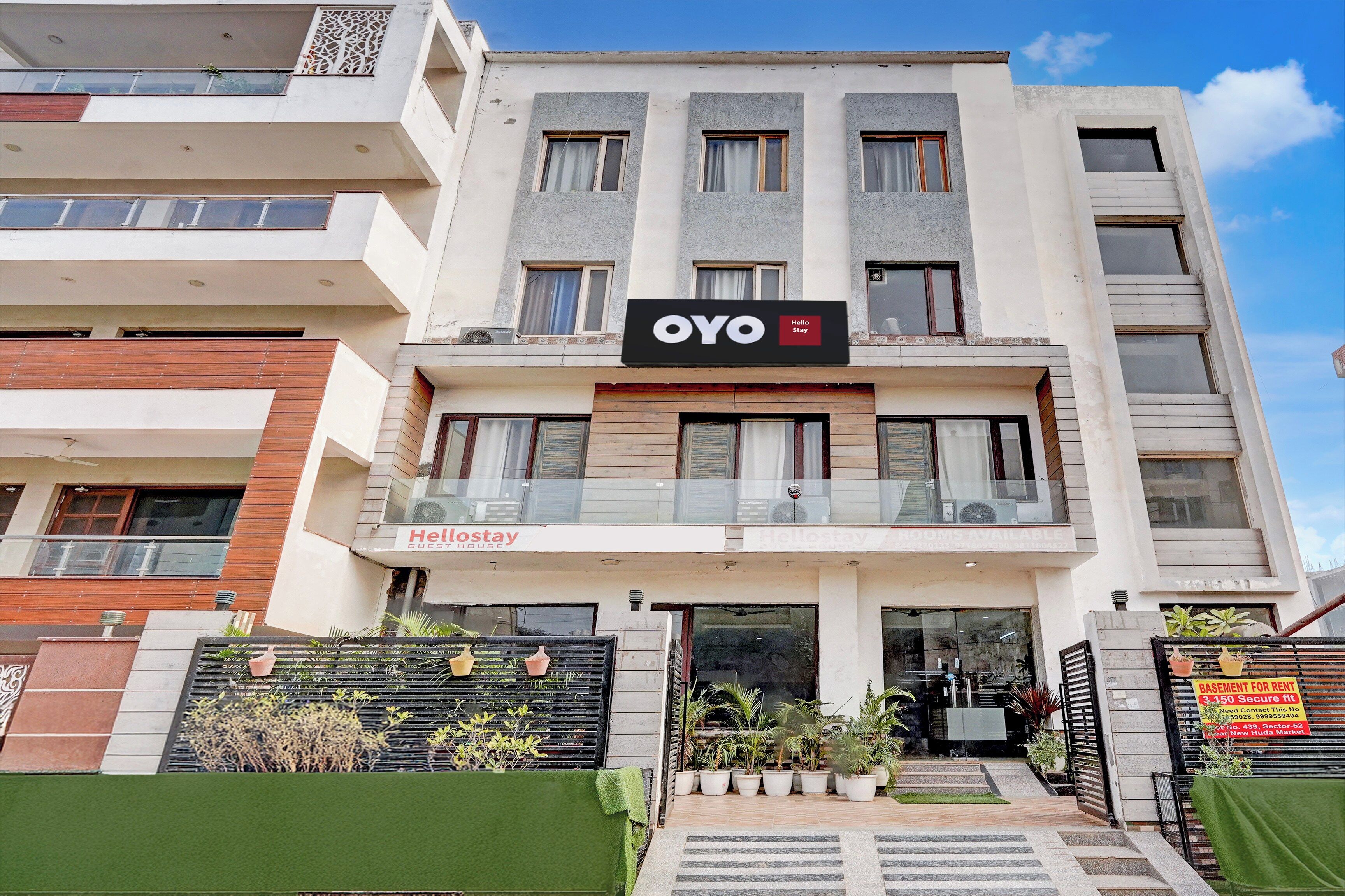 A multi-story building with a sign for 'OYO Stay' indicating it is a hotel.