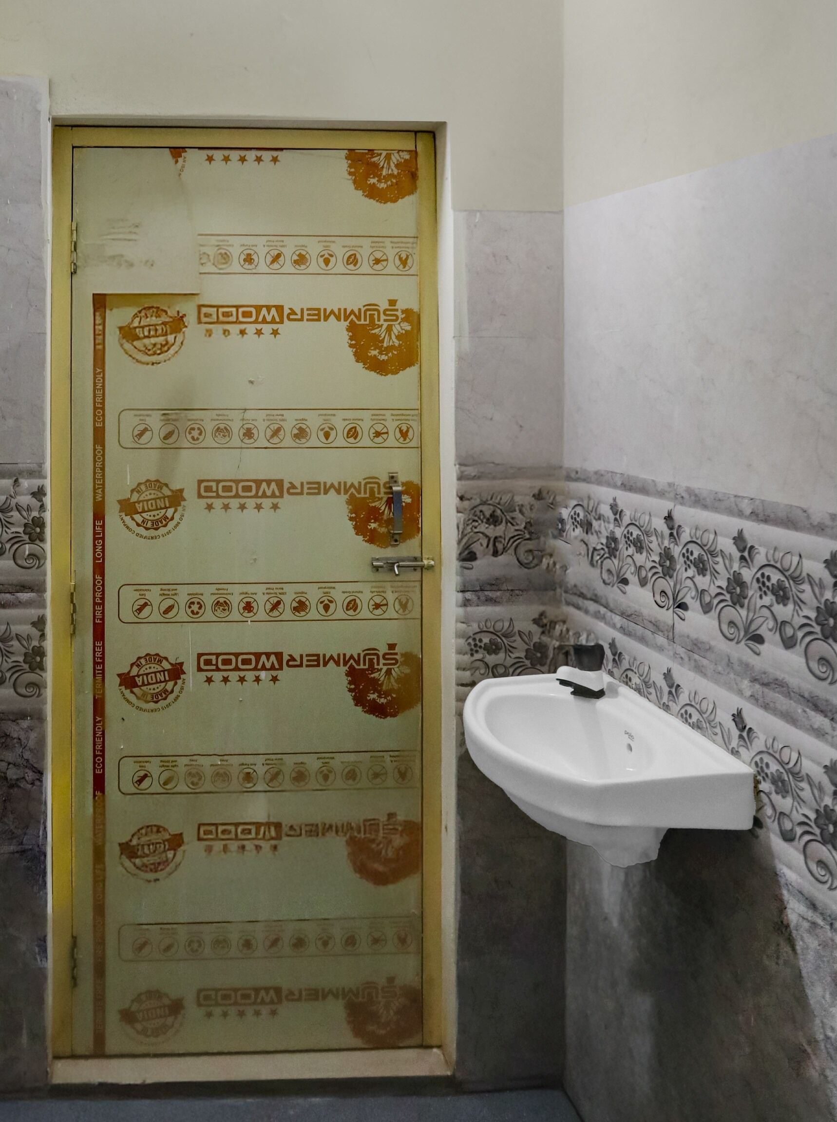 A bathroom with a door labeled 'SUMMER ROOM' and a sink.