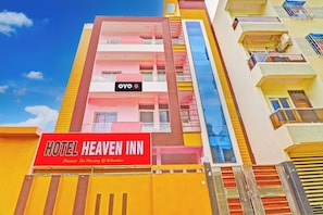 A multi-story hotel building with balconies and a prominent red sign for Hotel Heaven Inn. - Hotel O by OYO Heaven Inn (Gwalior)