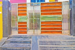 A metal gate with vertical bars and horizontal wooden slats. - Hotel O by OYO Heaven Inn (Gwalior)