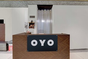 A reception desk with a sign that reads 'OYO' in a hotel lobby. - Hotel O Sukoon Guest House (Modinagar)